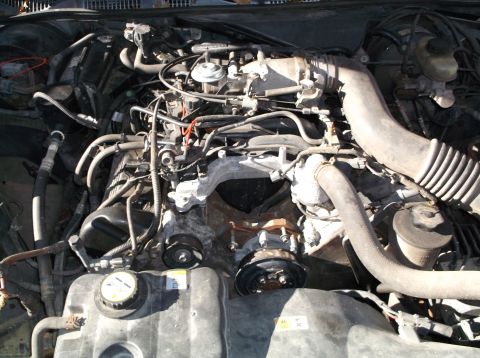 1974 Dodge Challenger - Close-up view of an engine bay, showing various mechanical parts and hoses.