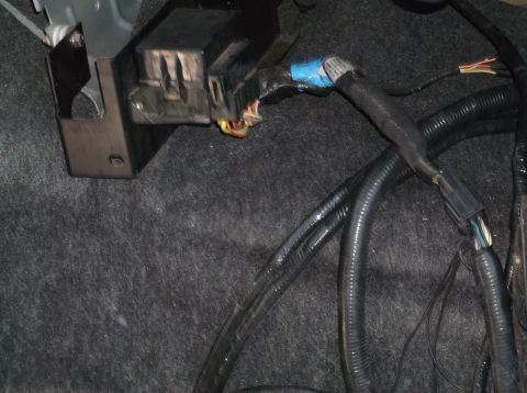 1974 Dodge Challenger - Close-up view of a vehicle's interior wiring harness and junction box, showing electrical connectors and black protective tubing.