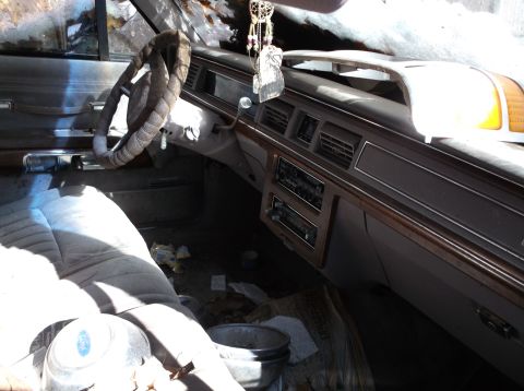 1974 Dodge Challenger - The interior of a car shows signs of disuse and neglect, with a dirty dashboard and floor.