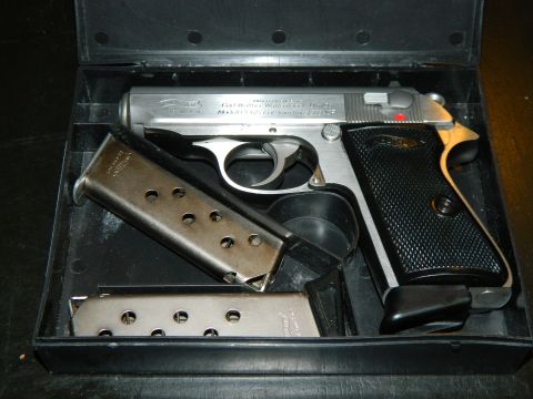 1979 Ford Bronco - A Walther PPK pistol and extra magazines are stored in a black case.