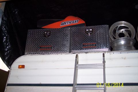 1973 Ford F-250 - Trailer top storage includes toolboxes, a snowmobile part, and spare wheels.