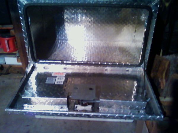 Aluminum underbox with lid open, showing diamond plate interior