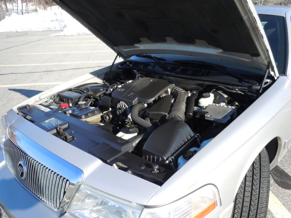 Silver sedan engine bay with hood open