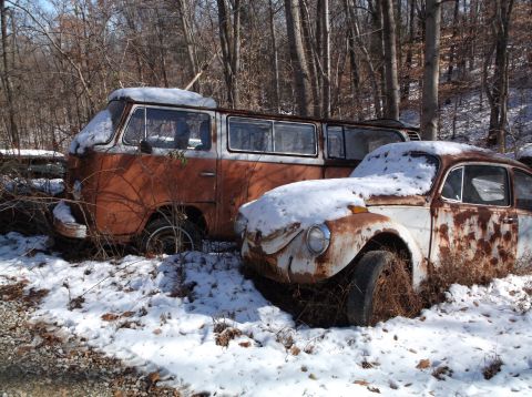 1974 Dodge Challenger - Two vintage Volkswagen vehicles, a Type 2 van and a Beetle, are parked in a snowy wooded area. The vehicles are rusted and covered in snow,…