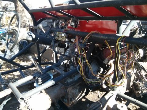 1986 Ford Bronco - The interior of a custom off-road vehicle, likely a dune buggy or sand rail, is shown with its exposed roll cage, steering wheel, and compl…