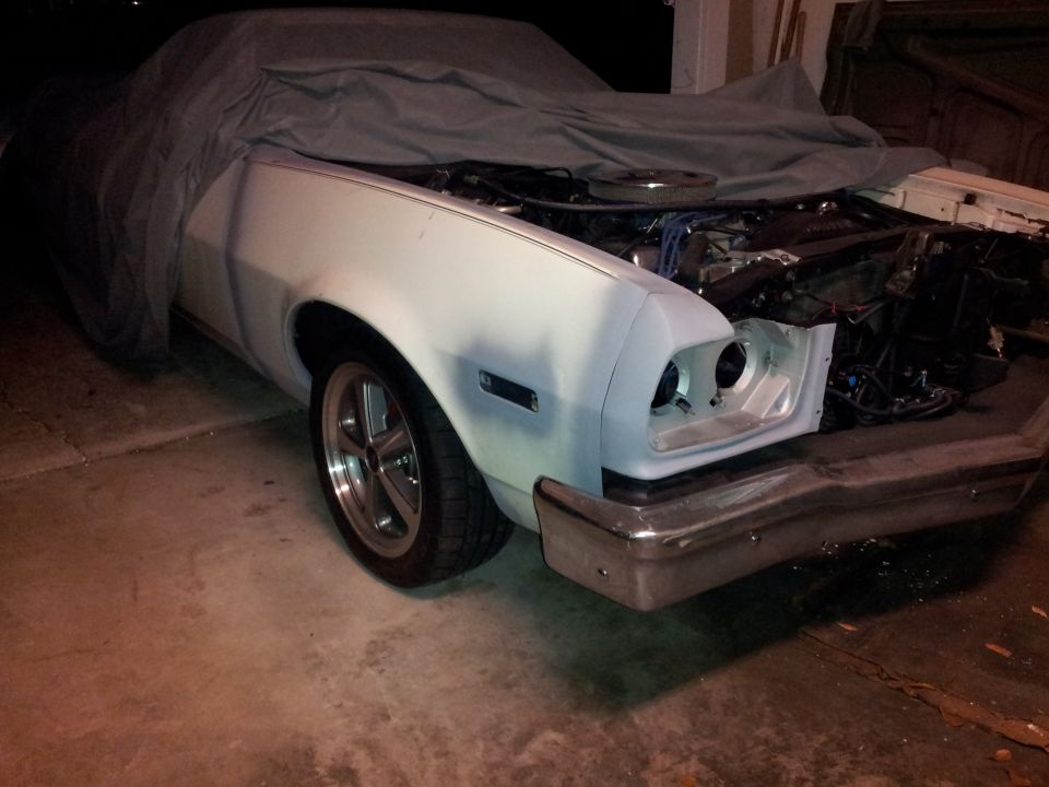 1976 Ford Ranchero with hood open, engine visible, primer front end, chrome bumper