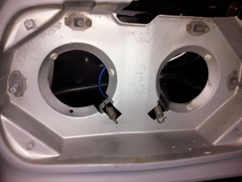 1976 Ford Ranchero - This is a close-up view of the headlight housing area of a vehicle, likely a 1976 Ford Ranchero, showing two circular openings for headligh…