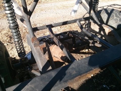 1986 Ford Bronco - The rear suspension and frame of a custom off-road vehicle, possibly a dune buggy or rock crawler, are visible. The image shows a heavy-dut…