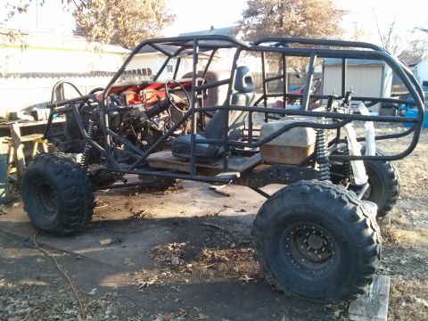 1986 Ford Bronco - A custom-built off-road buggy with a roll cage, large tires, and exposed engine components sits in an outdoor setting. The vehicle appears…
