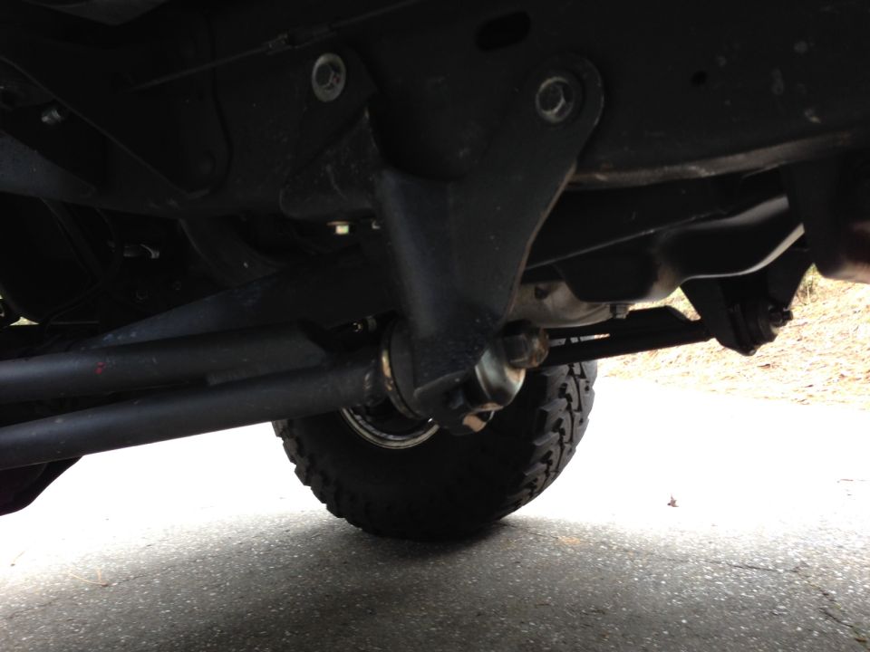 Undercarriage of a 1993 Ford Bronco showing suspension and steering components.