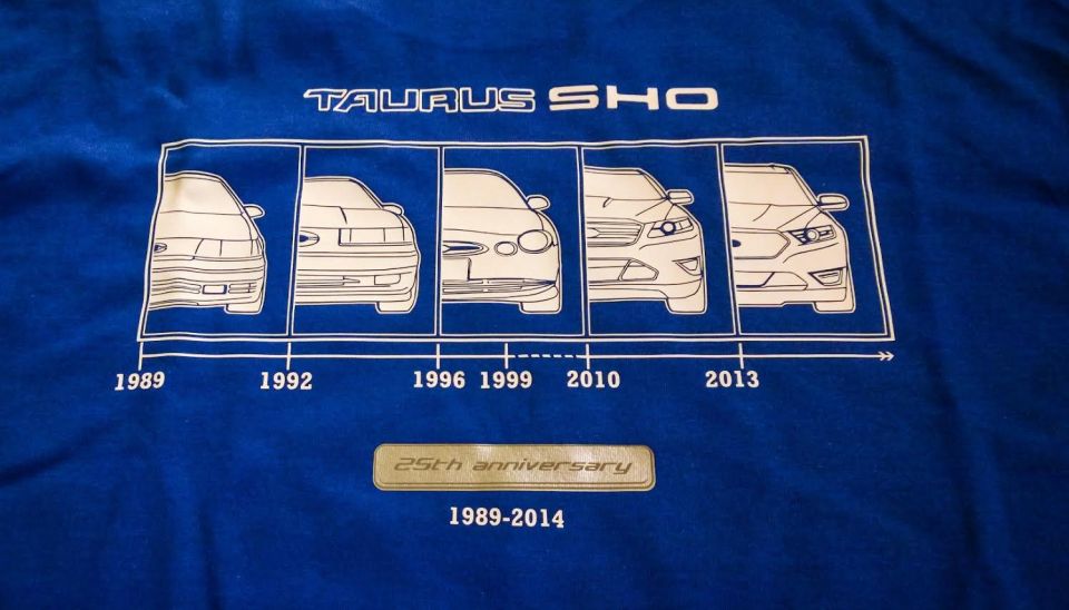Blue t-shirt graphic showing timeline of Ford Taurus SHO generations from 1989 to 2013