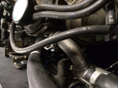 1988 Suzuki Samurai - Close-up view of an engine bay, showing various hoses and metal components.