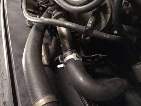 1988 Suzuki Samurai - Close-up view of an engine bay, showing various hoses and plumbing.