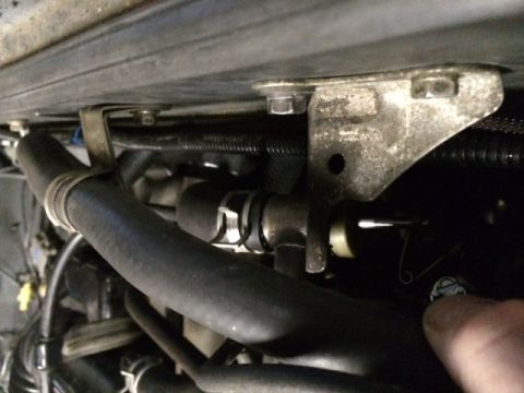 1988 Suzuki Samurai - Close-up view of engine bay components, including hoses and a metal bracket.