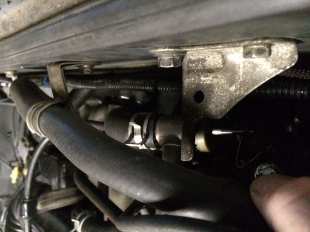 Close-up of a metal bracket and hose in an engine bay