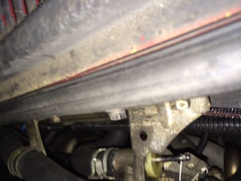 1988 Suzuki Samurai - This image shows a section of hoses and a mounting bracket within a vehicle's engine compartment.