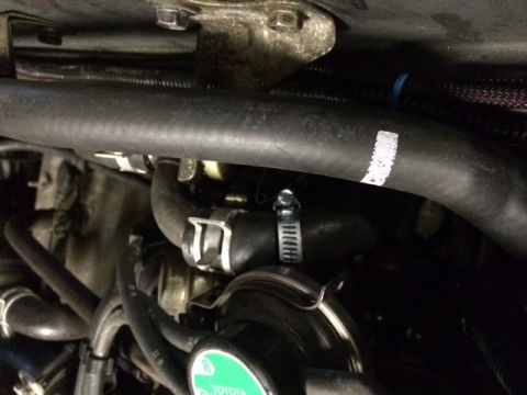 1988 Suzuki Samurai - Close-up view of engine bay hoses and clamps, with a white marker on one hose.