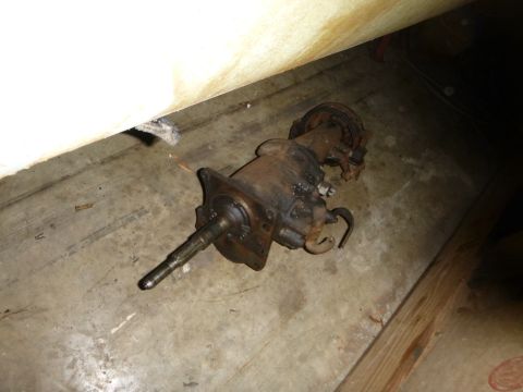 1953 Plymouth Belvedere - A rusty car transmission is shown on a concrete floor, possibly in a garage or workshop.