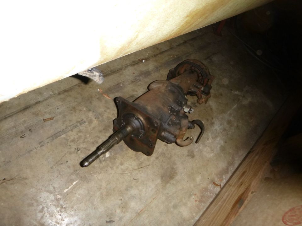 Old car transmission sitting on a concrete floor