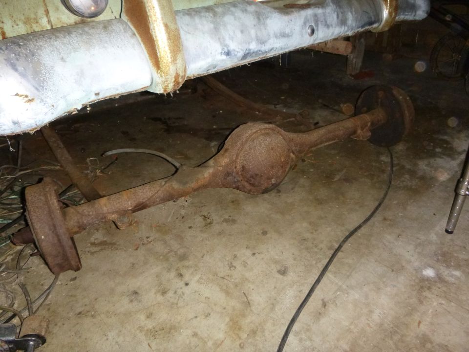Rusty rear axle assembly under a vehicle