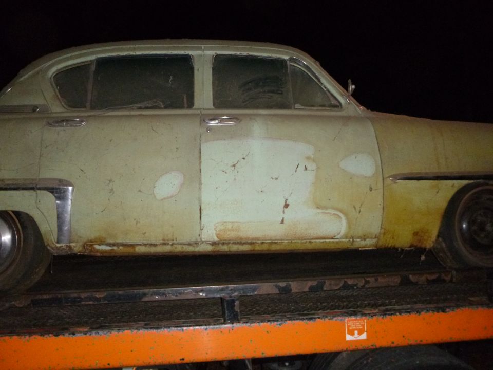 1953 Plymouth Belvedere sedan, side view, showing faded paint and rust