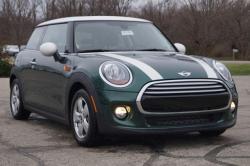 2010 MINI Cooper - A green MINI Cooper with white accents is parked on an asphalt lot.