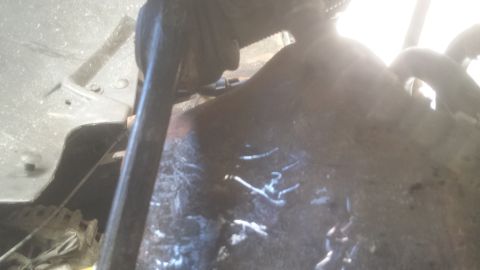 1991 Ford Bronco - This image shows the undercarriage of a vehicle, with visible rust and dirt accumulation.