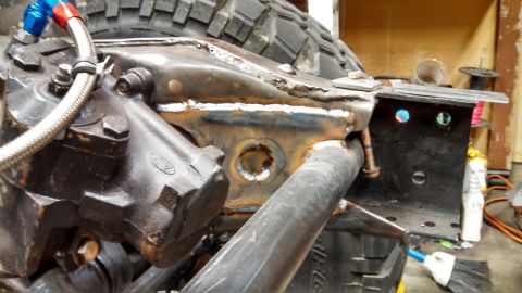 1967 Ford F-250 - Close-up view of a modified truck chassis, showing custom welding and mechanical parts.