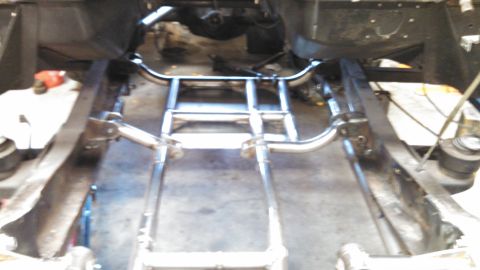 1967 Ford F-250 - The underside of a truck, focusing on the chassis and suspension components during a build or repair.