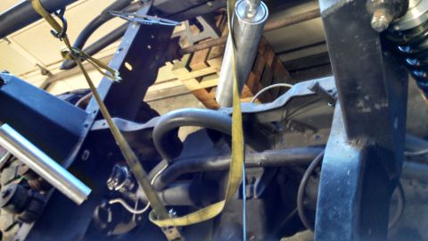 1967 Ford F-250 - Close-up view of a truck's frame and suspension system, with a yellow strap visible.
