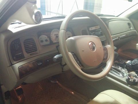 2000 Mercury Grand Marquis - The interior of a 2000 Mercury Grand Marquis features a custom gauge pod on the A-pillar and wood grain accents on the dashboard.