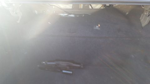 1991 Ford LTD Crown Victoria - The trunk of a car is shown, appearing empty except for some wiring and a small orange marker on the carpeted floor.