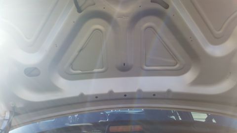1991 Ford LTD Crown Victoria - The underside of a car's hood is shown, with no visible year-identifying features.