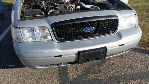 1991 Ford LTD Crown Victoria - Front view of a silver Ford Crown Victoria, hood raised to reveal the engine compartment.