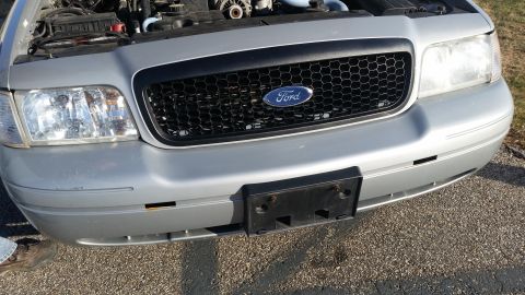 1991 Ford LTD Crown Victoria - Front view of a silver Ford Crown Victoria, a black honeycomb grille with the Ford emblem.
