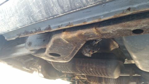 1991 Ford LTD Crown Victoria - Underside view of a vehicle, highlighting significant rust on the frame and exhaust system.