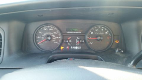 1991 Ford LTD Crown Victoria - Photograph of a Ford vehicle instrument cluster with speedometer and tachometer, not a document.