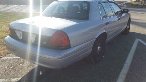 1991 Ford LTD Crown Victoria - Photograph of a silver Ford Crown Victoria sedan in a parking lot, not a technical document.