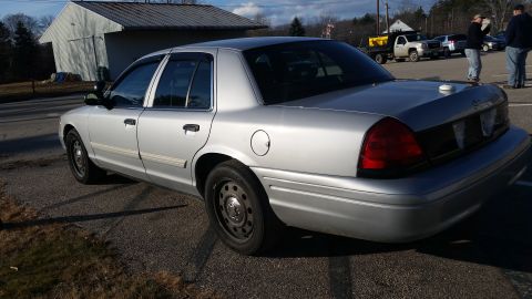 1991 Ford LTD Crown Victoria - Silver sedan parked on asphalt with a building in the background.