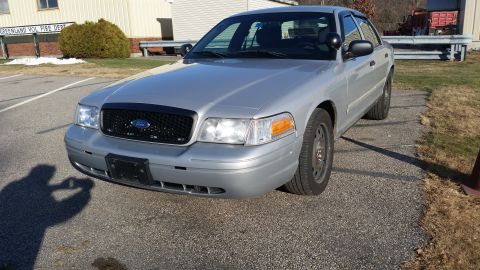 1991 Ford LTD Crown Victoria - This silver Ford Crown Victoria, likely a later model, is shown from the front three-quarter angle.