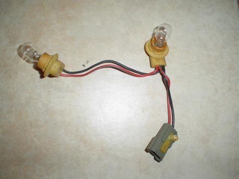 1992 Ford Explorer - A wiring harness with two light bulbs and a gray connector is shown.