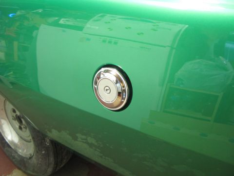 1971 Ford Ranchero - Close-up of the side of a green 1971 Ford Ranchero, showing the fuel filler door and part of the rear wheel.