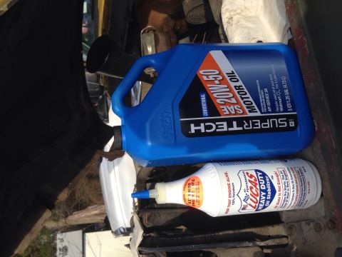1979 Ford Bronco - Motor oil and oil stabilizer bottles are visible, suggesting maintenance or repair work.