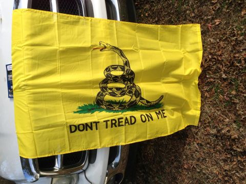 1979 Ford Bronco - A Gadsden flag is displayed on the back of a vehicle, with the text 'DONT TREAD ON ME' clearly visible.