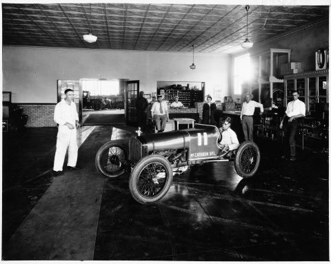 1909 Ford Model T - A McCathren Special racing car is displayed indoors with a group of people observing.
