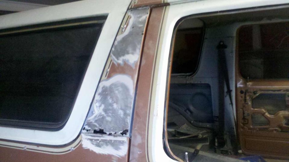 1982 Ford Bronco interior showing door panel removed and bodywork on B-pillar