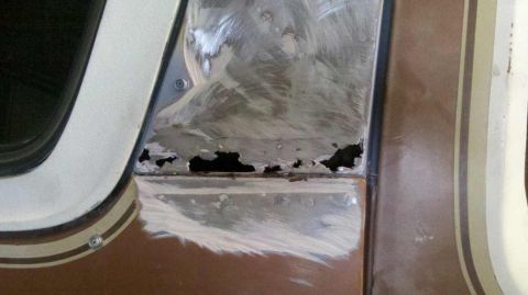 1982 Ford Bronco - This vehicle panel shows significant rust damage and has been sanded in preparation for repair.