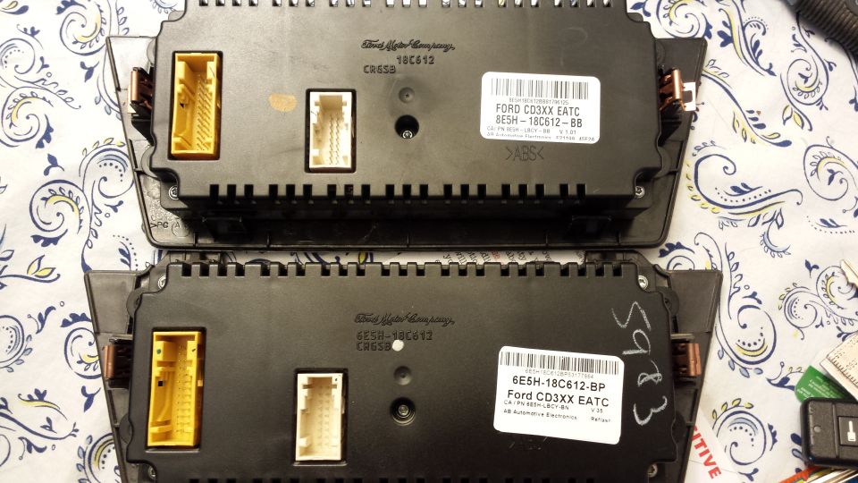 Two Ford instrument clusters with labels indicating Ford CD3XX EATC and part numbers