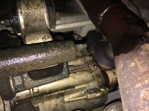 2011 Ford Elite - Close-up view of greasy powertrain components, likely from a vehicle's undercarriage.