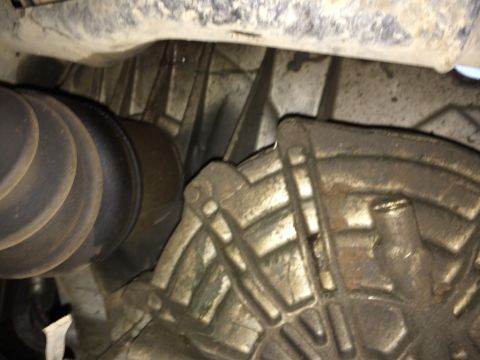 2011 Ford Elite - Underside view of a vehicle's drivetrain components, including a driveshaft boot and transmission housing.